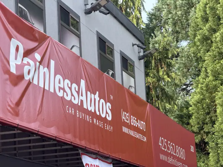 The red Painless Autos storefront sign: Car buying made easy, (425) 866-AUTO